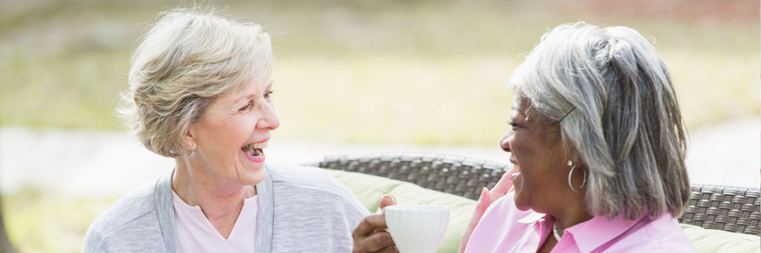 two elderly woman talking and laughing